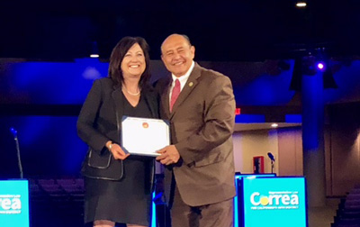 Deirdre receiving Congressman Lou Correa's Women of Distinction Award